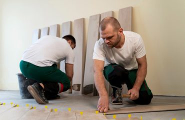 Commercial flooring contractor inspecting subfloor before installation