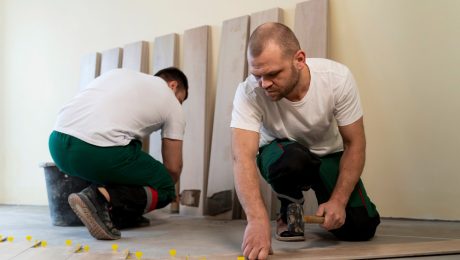 Commercial flooring contractor inspecting subfloor before installation